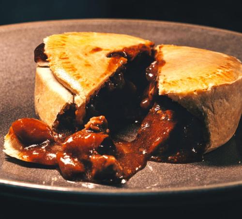 a sandwich on a plate with sauce on it at Westmorland Hotel Tebay in Tebay