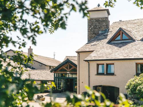 a house with a chimney on top of it at Westmorland Hotel Tebay in Tebay