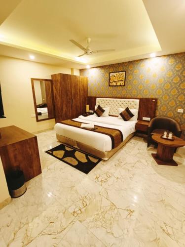 a hotel room with a bed and a desk and a table at Mayda Inn- A Boutique Hotel in New Delhi