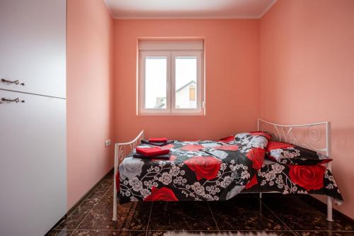 a bedroom with a bed and a window at Mici Luxury Apartments in Ledine