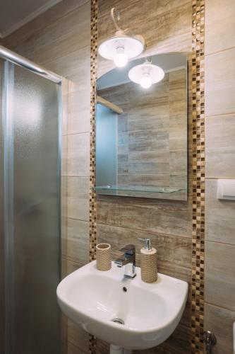a bathroom with a sink and a mirror at Mici Luxury Apartments in Ledine