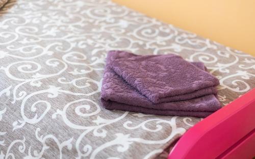 a pair of towels sitting on top of a bed at Mici Luxury Apartments in Ledine