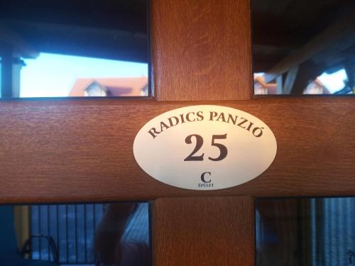 a wooden door with a sign that reads pandas panama c at Radics Panzió Étterem és Pihenő Központ in Letenye