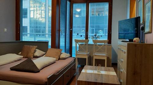 ブダペストにあるCleopatra Apartment Budapestのソファ、デスク、窓が備わる客室です。