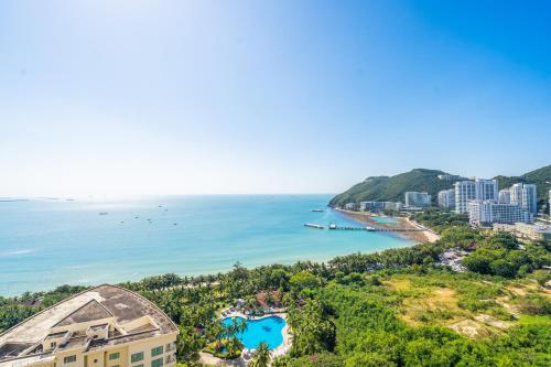 an aerial view of a city and the ocean at Sanya Yikehai View Apartments in Sanya