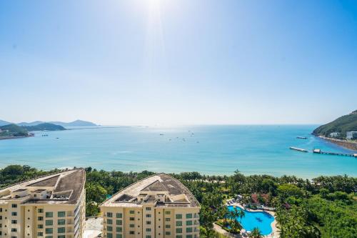 an aerial view of the ocean and buildings at Sanya Yikehai View Apartments in Sanya