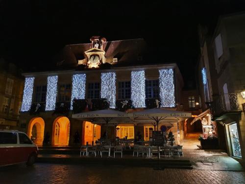 a building with christmas lights on it at night at Sarlat.Catalina in Sarlat-la-Canéda