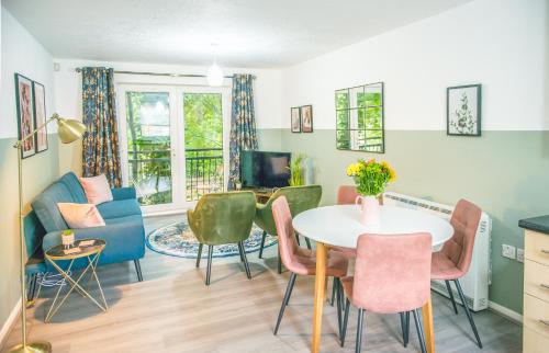 a living room with a table and chairs at Pipkin Place Serviced Apartment Coventry in Coventry
