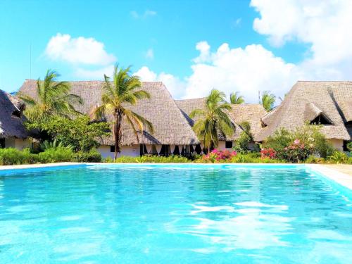 a swimming pool in front of a resort at Mambrui Villa 34, Villa 36 in Malindi