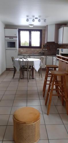 a kitchen with a table and chairs in a kitchen at Chez Laurette et Louis in Ugine