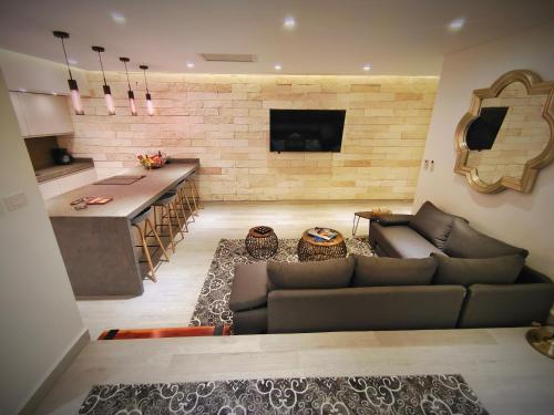 a living room with a couch and a kitchen at 1st Luxury Warehouse in Cancún