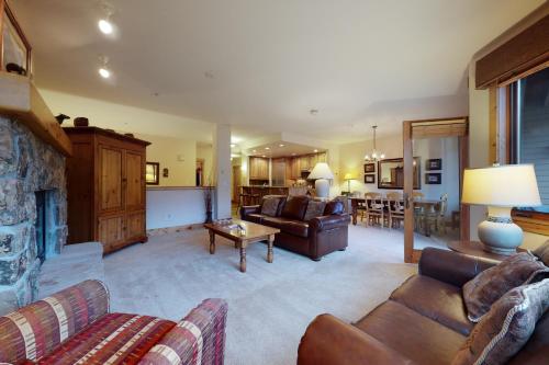 a living room with a couch and a table at Antlers in Steamboat Springs