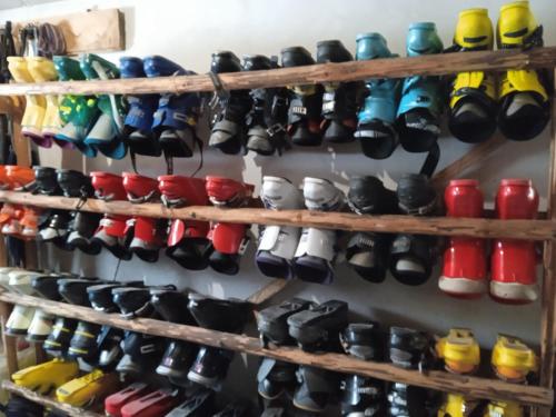 a bunch of shoes are lined up on a wall at У ДЯДЬКА in Pilipets