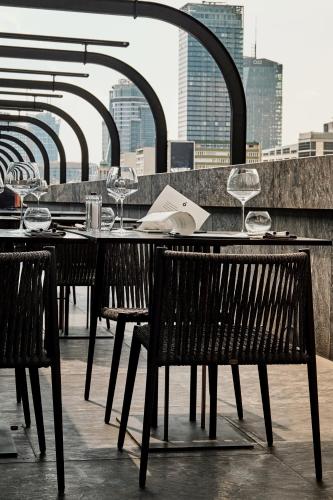 a table with wine glasses on top of a building at Hotel Warszawa in Warsaw