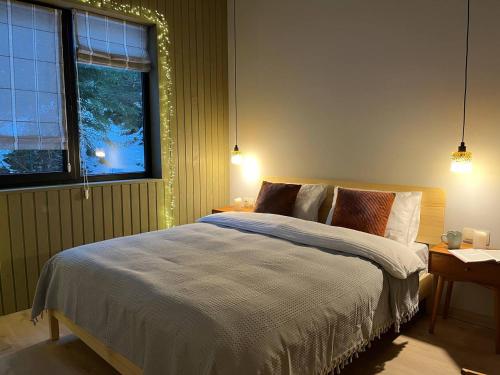 a bedroom with a bed and a window at Над фермою in Nizhne-Studënyy
