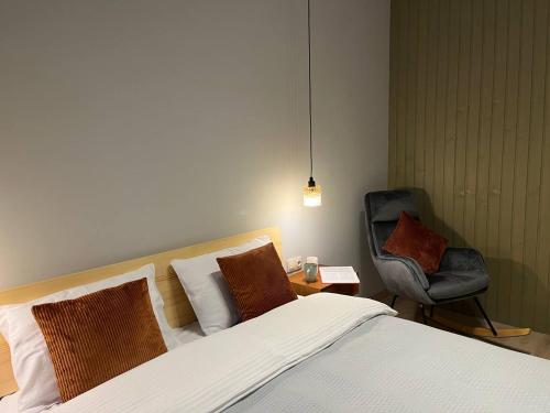a hotel room with a bed and a chair at Над фермою in Nizhne-Studënyy