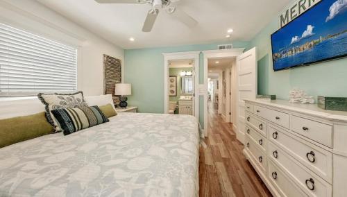 a bedroom with a large bed and a dresser at Canal Lower-Gorgeous 3 bed 3 bath near SK Village in Siesta Key