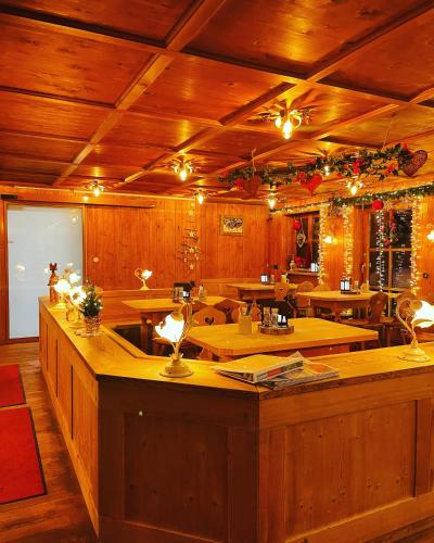 a large room with wooden walls and wooden tables at Landgasthof Zum Alten Reichenbach in Nesselwang