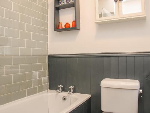 a bathroom with a tub and a toilet and a sink at 32 Church Hill in Telford