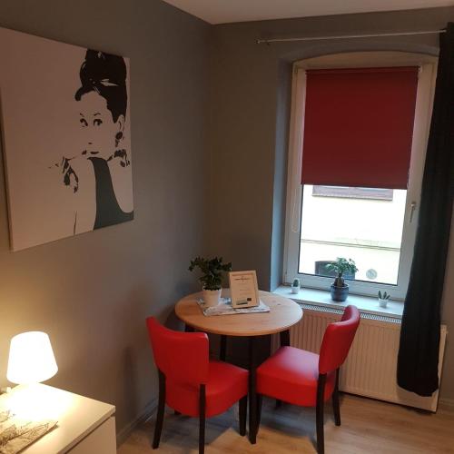 a room with a table and chairs and a window at Flensburg City - 24h in Flensburg