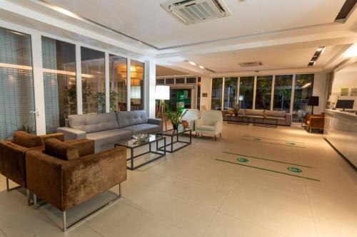 a large living room with a couch and chairs at Ecco Hotel Fortaleza in Fortaleza