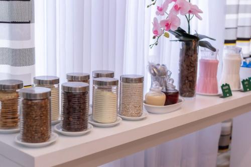 a shelf with many different jars of spices at Ecco Hotel Fortaleza in Fortaleza