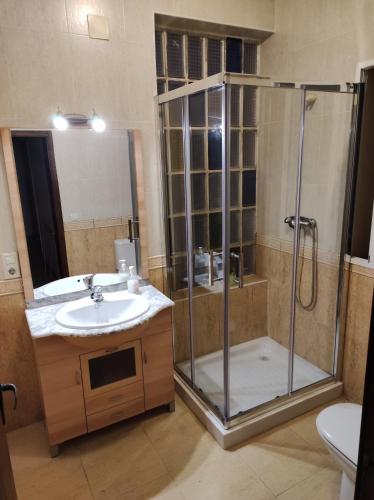 a bathroom with a shower and a sink and a toilet at CHALET MONTPRATS, SERRA in Serra