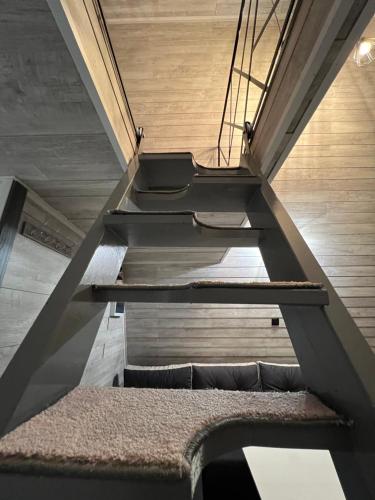 a staircase in a house with a rug on the floor at AGLAS CHALET in Moieciu de Jos