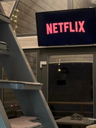 a netflix sign in front of a store at AGLAS CHALET in Moieciu de Jos