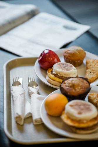 a tray with two plates of donuts and forks at Mountaineer Lodge in Lake Louise
