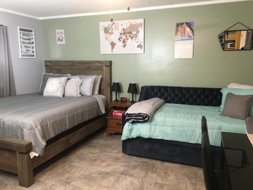 a bedroom with two beds and a couch at Home Away From Home, Recently Renovated in North Troy