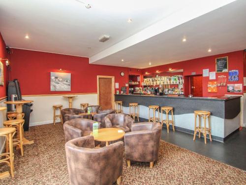 a bar in a restaurant with chairs and a counter at 60 Valley Lodge in Callington