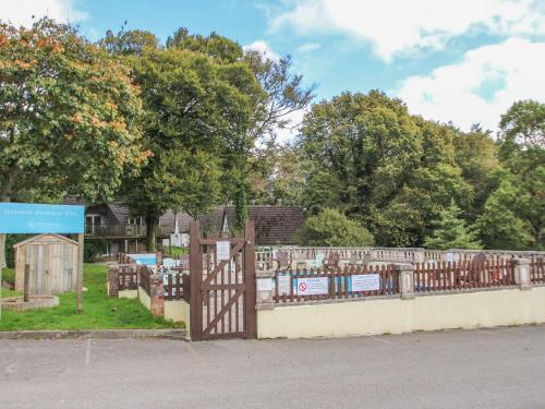 a fence with a gate in front of a cemetery at 60 Valley Lodge in Callington