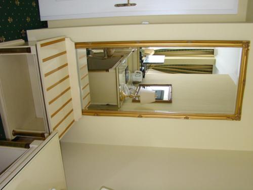 a bathroom with a mirror on the wall at Hotel Saint Petersburg in Karlovy Vary