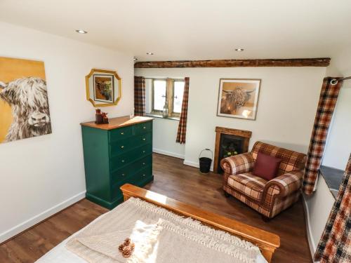 a living room with a green dresser and a couch at The Gatehouse in Sutton in Ashfield