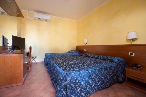 Postel nebo postele na pokoji v ubytování Albergo Dei Leoni