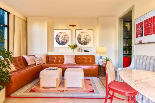 a living room with a couch and a table at Virgin Hotels New Orleans in New Orleans