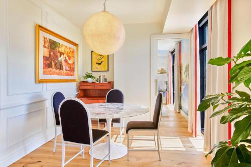 a dining room with a table and chairs at Virgin Hotels New Orleans in New Orleans