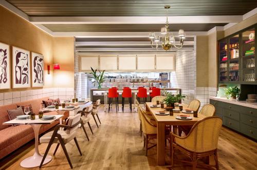 a restaurant with tables and chairs in a room at Virgin Hotels New Orleans in New Orleans