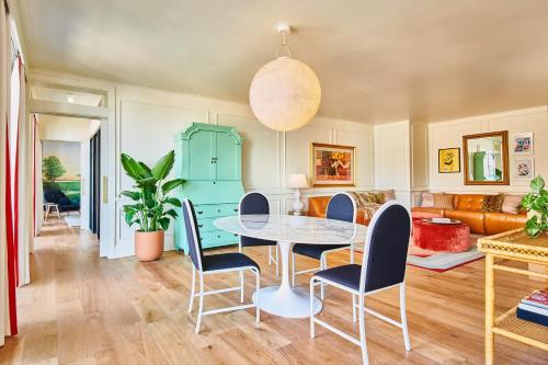 a dining room with a table and chairs at Virgin Hotels New Orleans in New Orleans