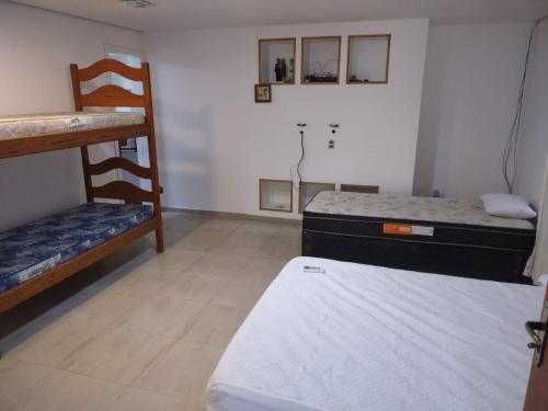 Una cama o camas en una habitación de Pousada Familiar Morada do Rapha