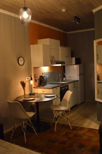 a kitchen with a table and chairs in a room at Chez Henri in Stavelot