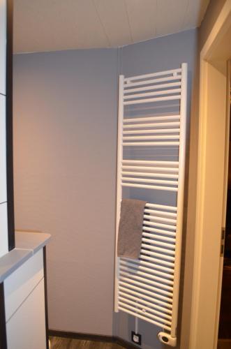 a bathroom with a shutter on the wall at Chez Henri in Stavelot