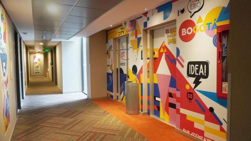 a hallway in a hospital with a colorful wall at ibis budget Bogota Marly in Bogotá
