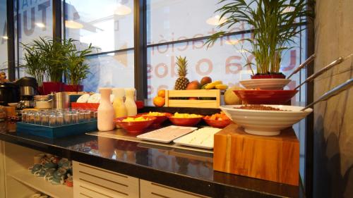 a kitchen counter with fruits and vegetables on a table at ibis budget Bogota Marly in Bogotá