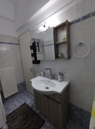 a bathroom with a sink and a shower at See and City Apartment in Aigio