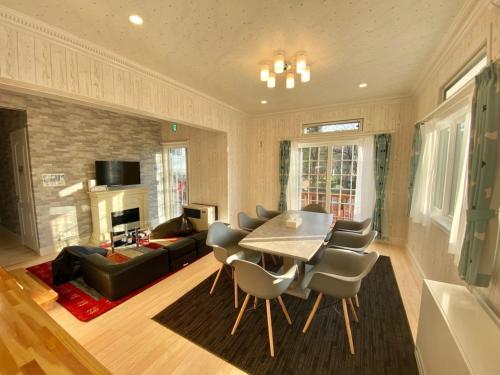 a living room with a table and chairs and a couch at Polar House ShinKaruisawa1 - Vacation STAY 00271v in Karuizawa