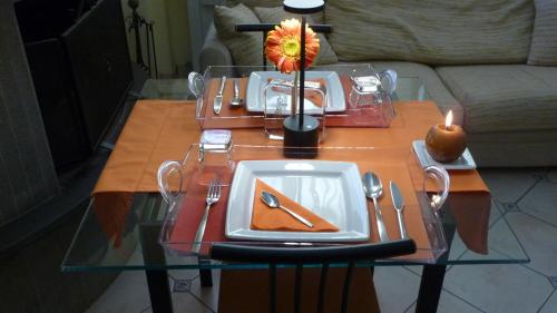 a table with a plate and a flower on it at B&B degli Artisti in Palmi