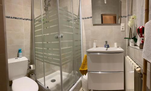 a bathroom with a shower and a toilet and a sink at La Liberté in Narbonne