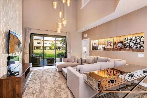 a living room with a couch and a tv at Magic Village 4 Bedroom! Welcome Home! in Orlando